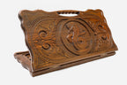 Carved beechwood backgammon board with twin serpents around a floral ornament, propped open
