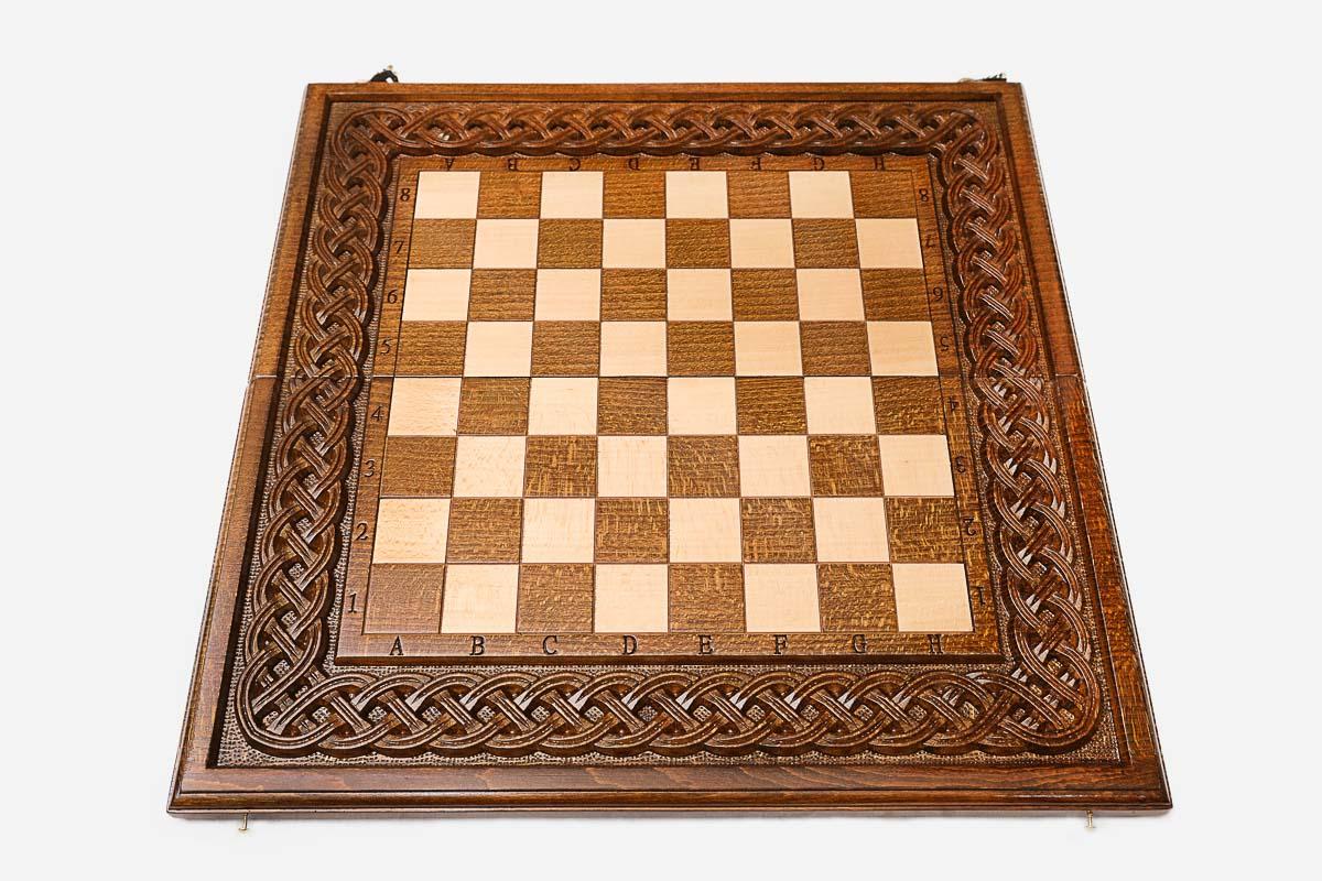 Twisted-rope carving framing the wooden chessboard