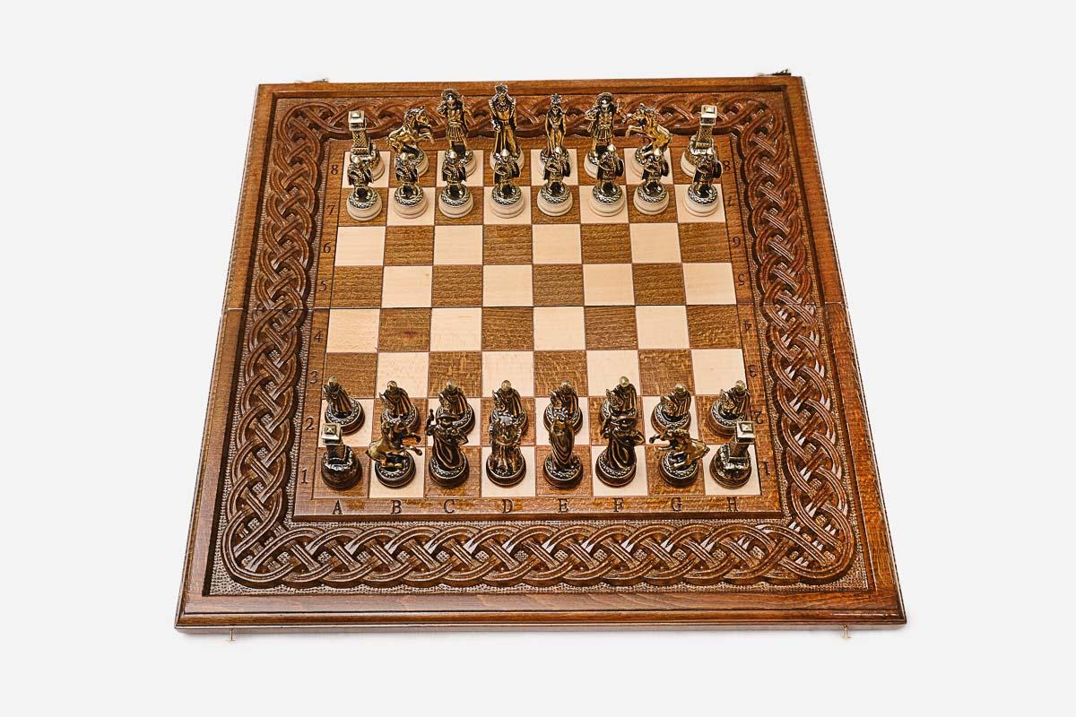 Figural bronze chess pieces on the rope-border board
