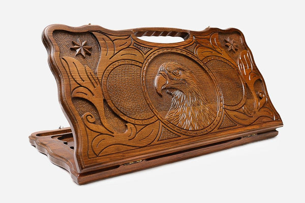 Carved beechwood backgammon board with an eagle between carved stars, propped open