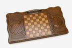 Angled view of the tree of life carved backgammon board
