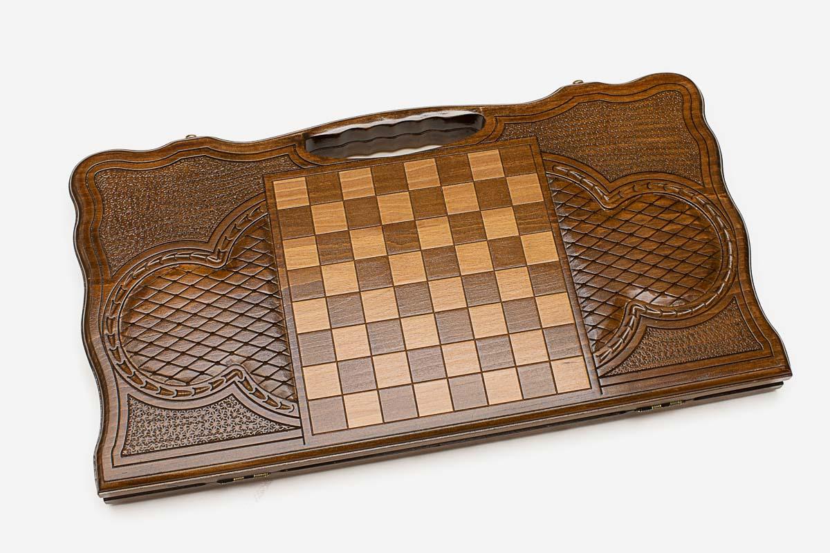 Angled view of the tree of life carved backgammon board
