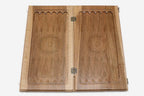 The carved basket-weave lattice and floral scrollwork across the closed board