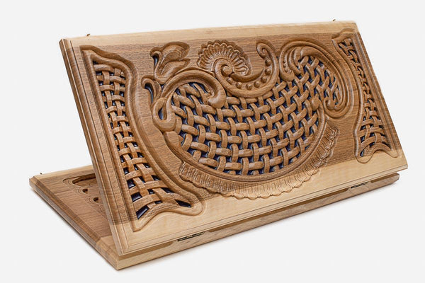 Folding walnut backgammon board with a hand-carved woven lattice panel over blue epoxy, propped open