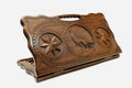 Carved beechwood backgammon board with a wolf between carved stars, propped open