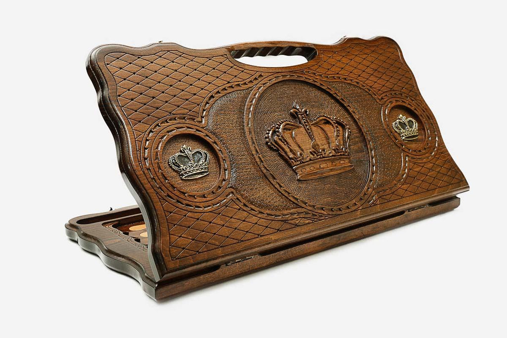 Carved beechwood backgammon board with a crown and bronze details, propped open