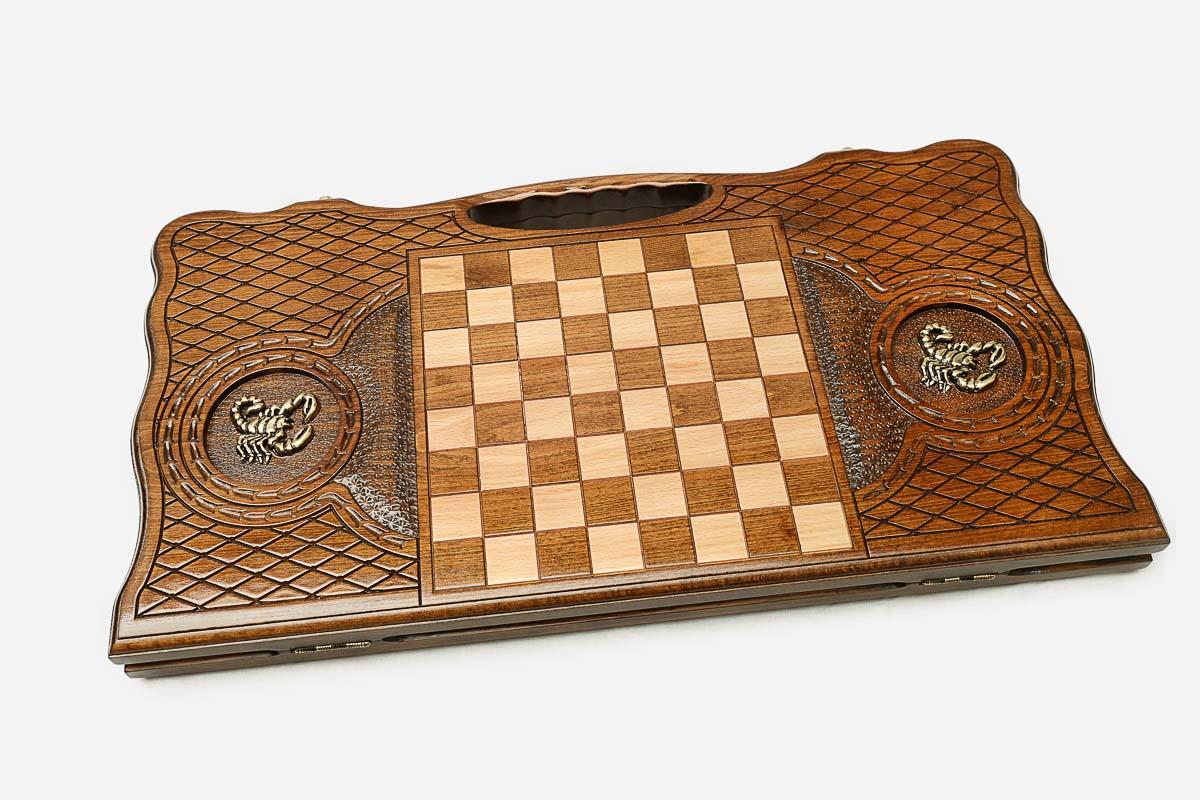 Angled view of the bronze scorpion carved backgammon board