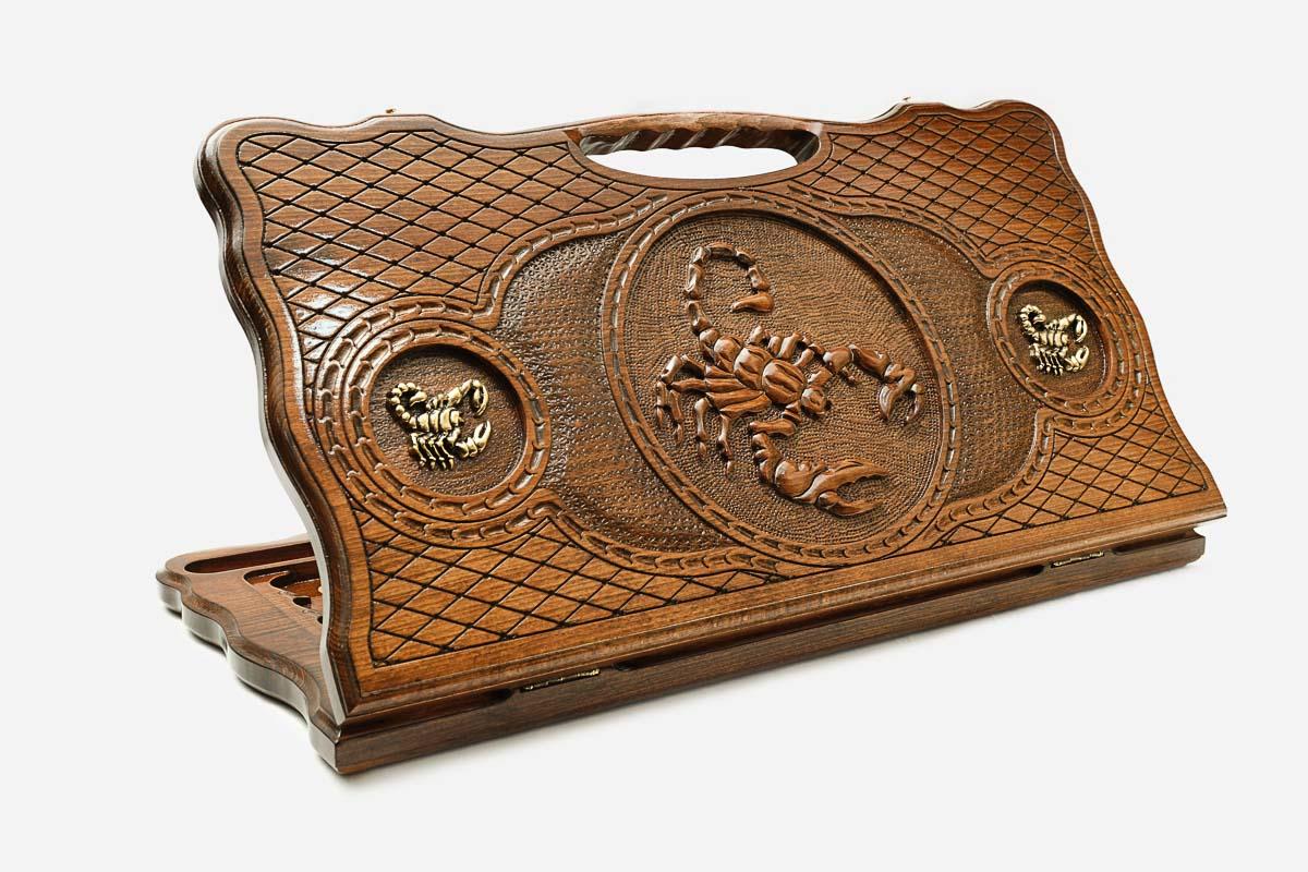 Carved beechwood backgammon board with a scorpion and bronze details, propped open