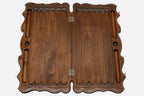 The backgammon board opened to show the wooden playing surface