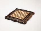 Hand-carved chess pieces in light and dark wood