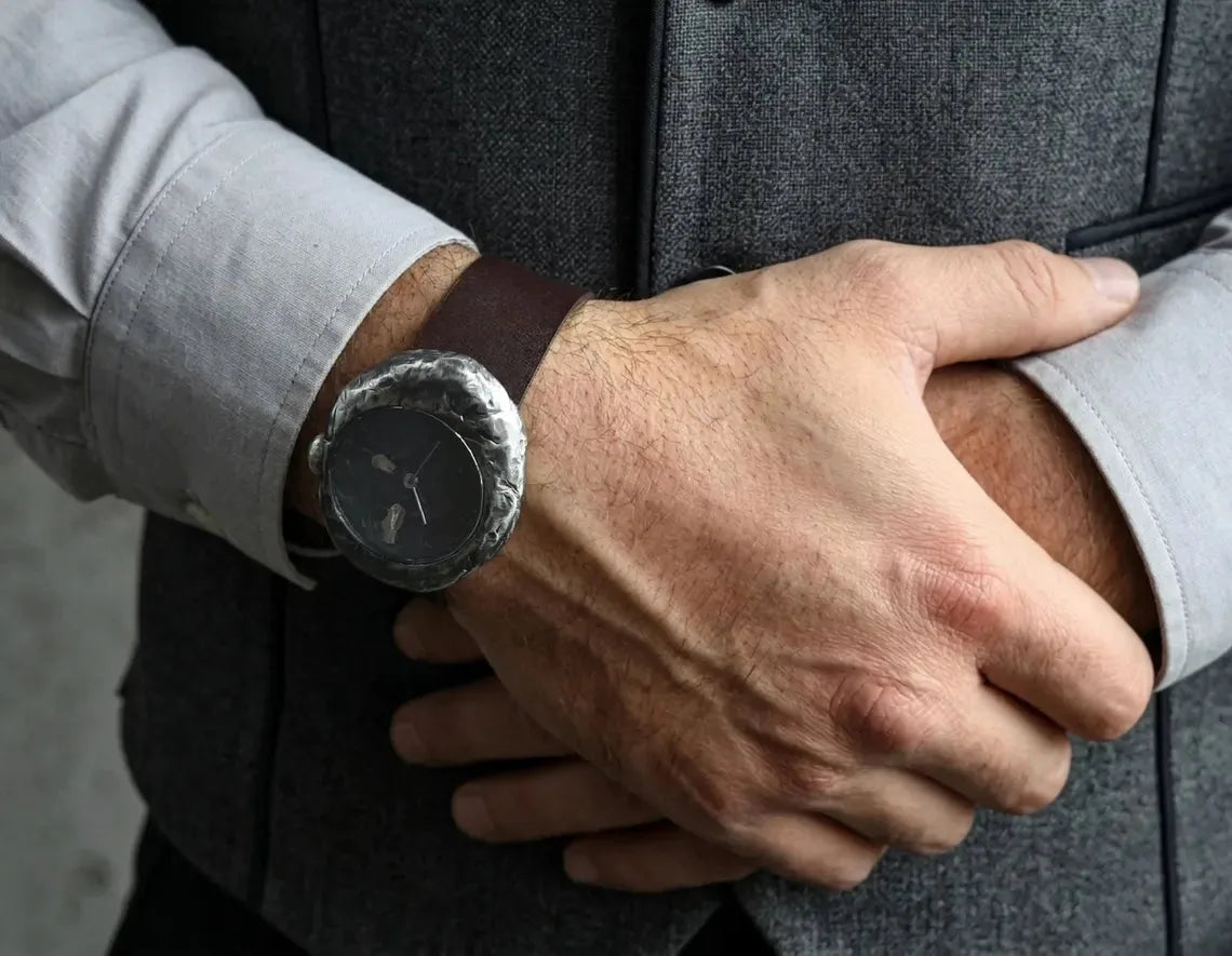 Artisan silver watch with hammered river rock finish and leather strap
