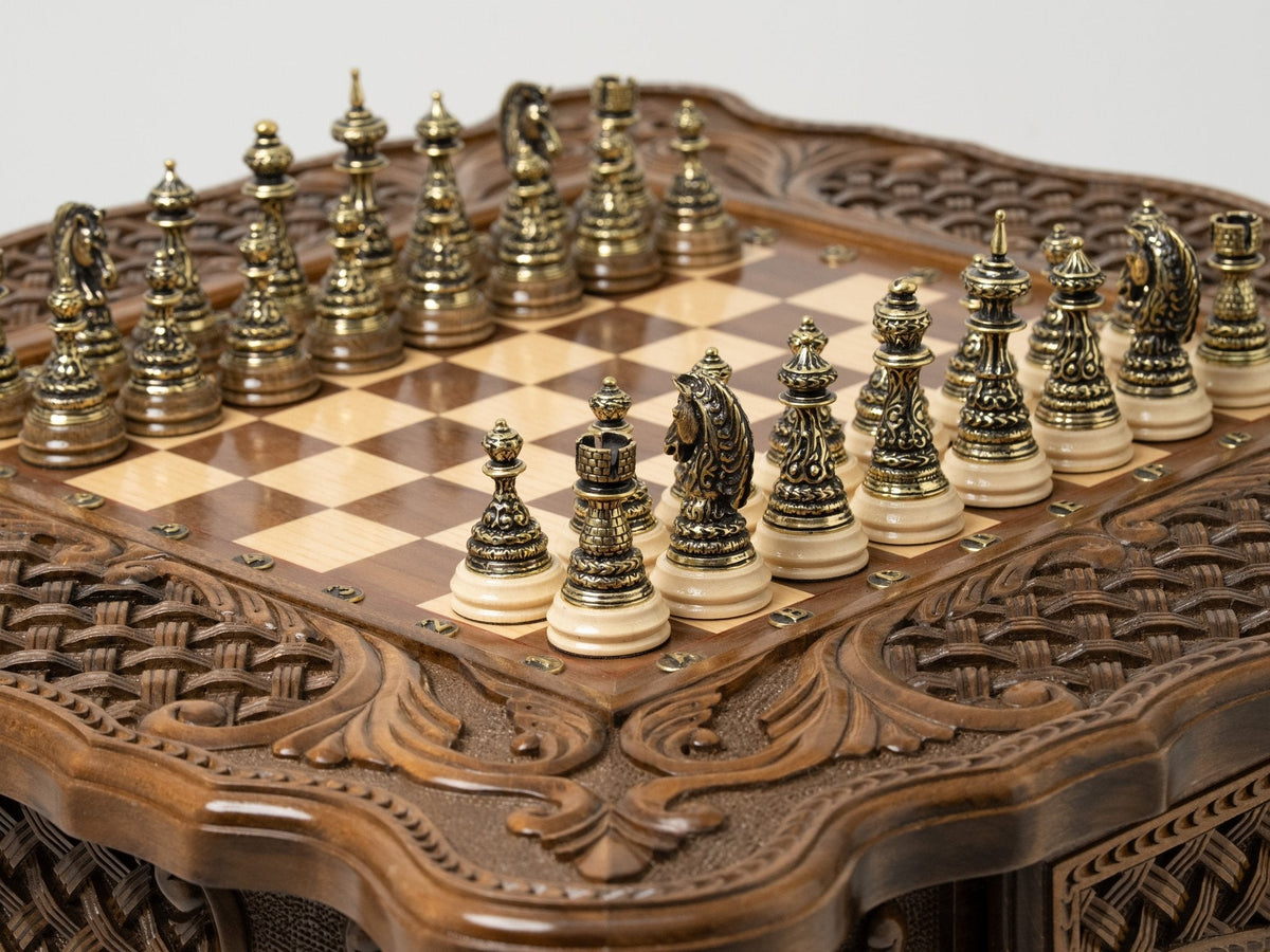 Carved wooden chess table set up with luxury bronze pieces