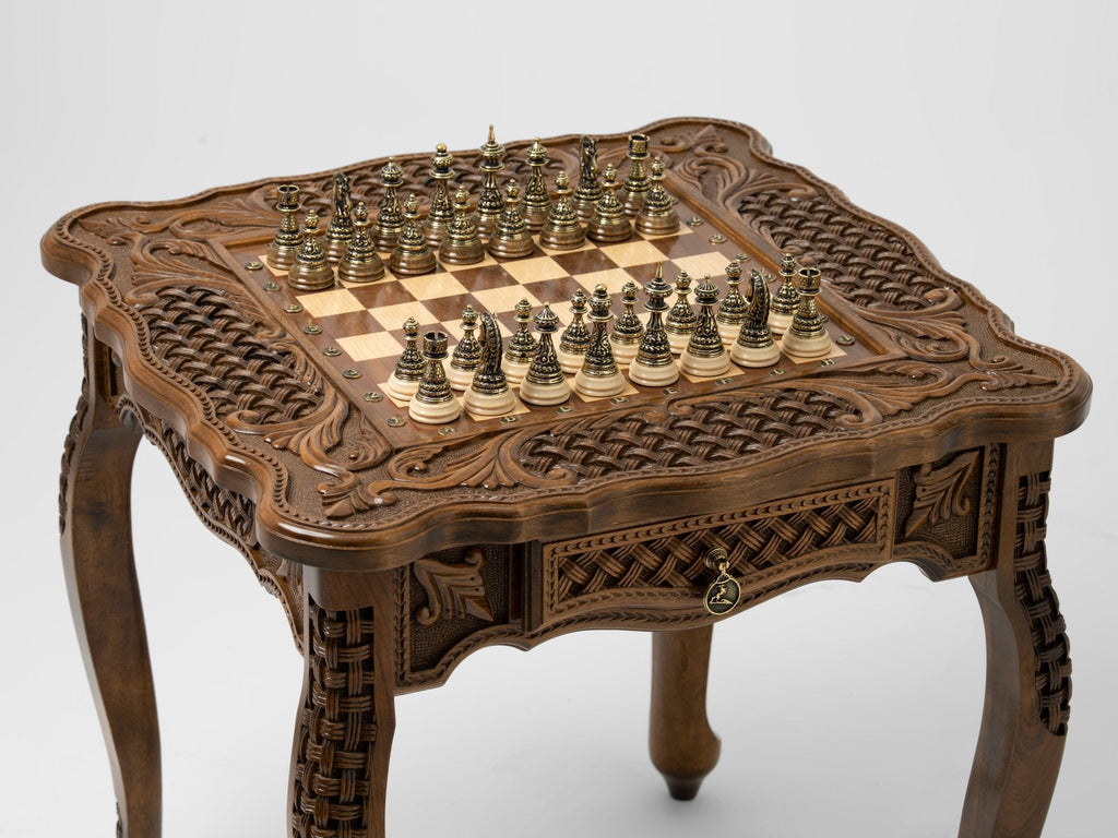 Close-up of the chessboard with bronze pieces on the wooden table
