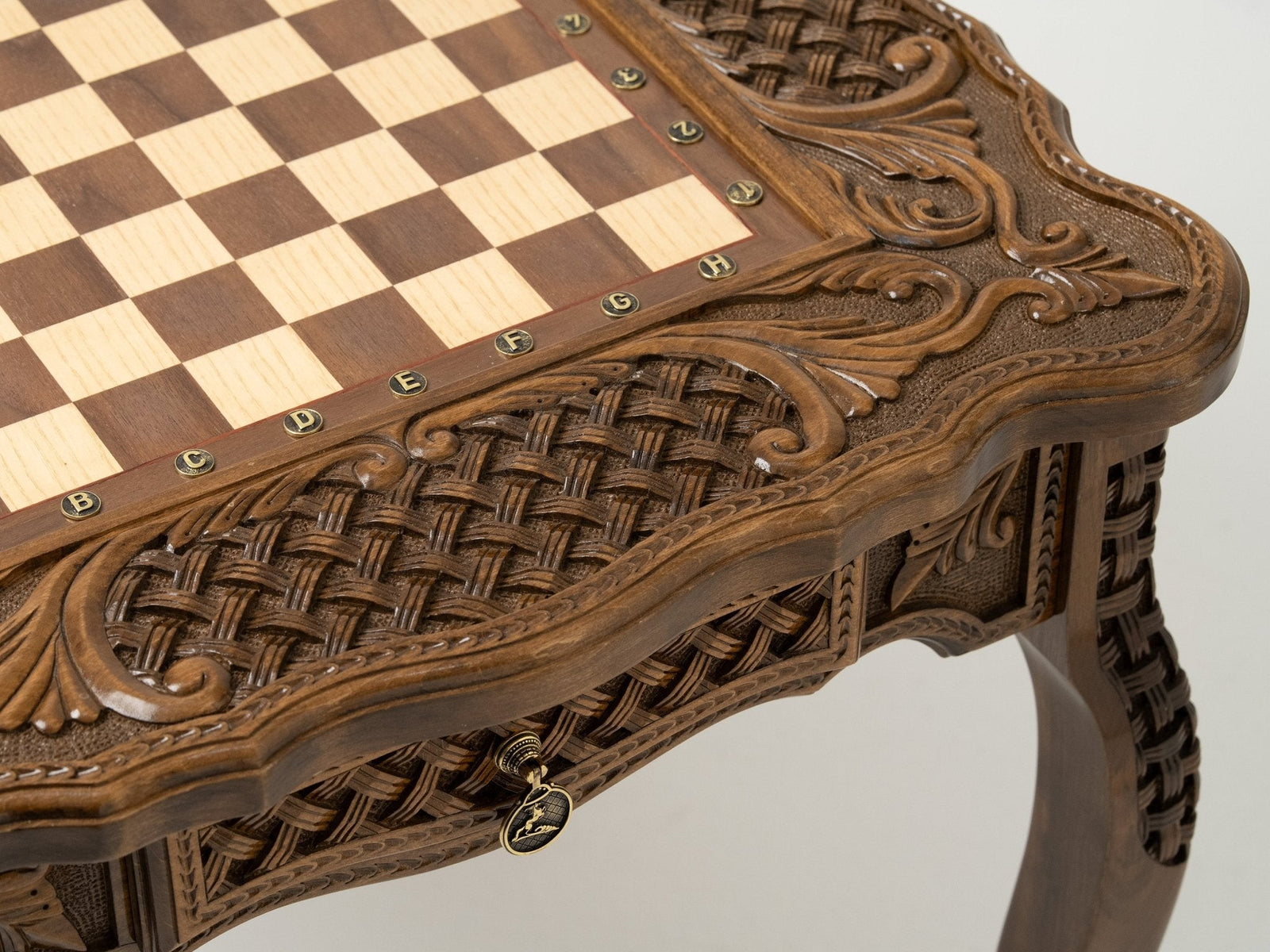 Carved border detail of the bronze-piece chess table