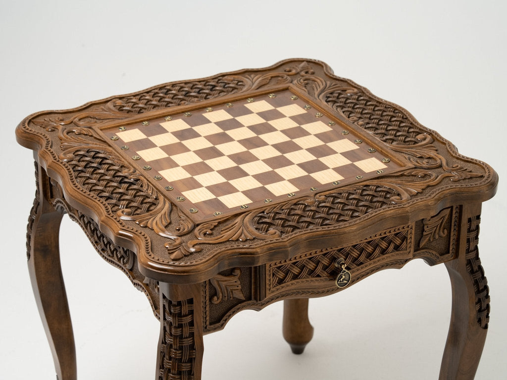 Carved legs of the wooden chess table