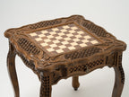 Carved legs of the wooden chess table