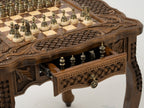 Bronze chess pieces arranged on the wooden board