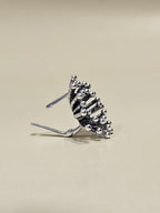 Side profile of handmade Dandelion silver earring with lever-back closure