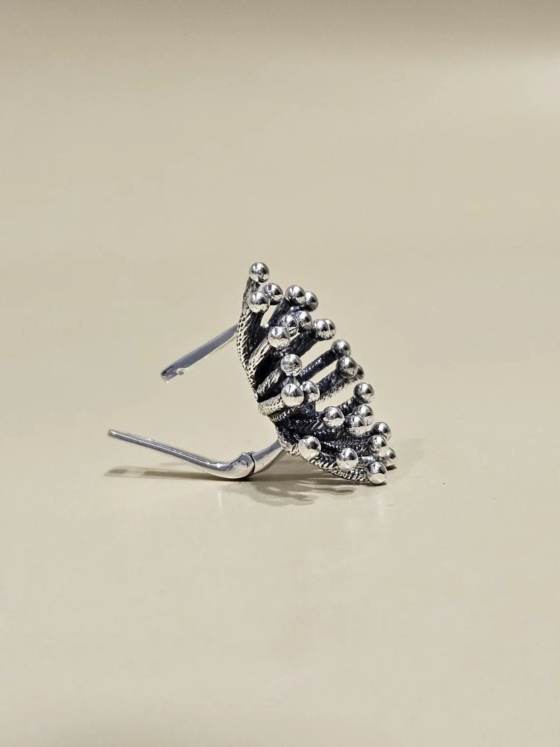 Side profile of handmade Dandelion silver earring with lever-back closure