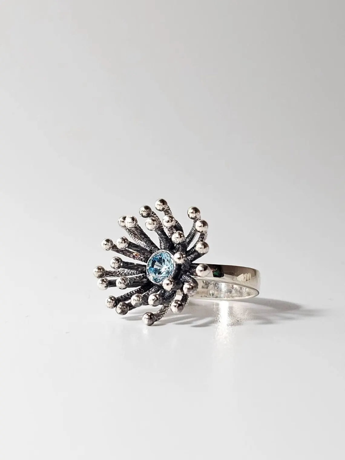 Dandelion sterling silver statement ring with sparkling sky-blue gemstone