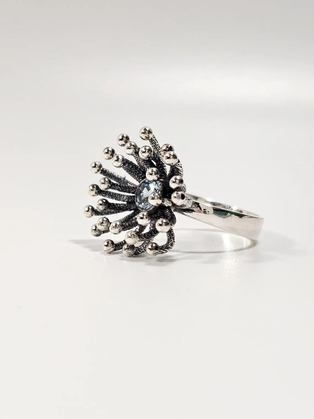 Side view of Dandelion silver ring showing beaded starburst design