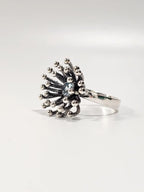 Side view of Dandelion silver ring showing beaded starburst design
