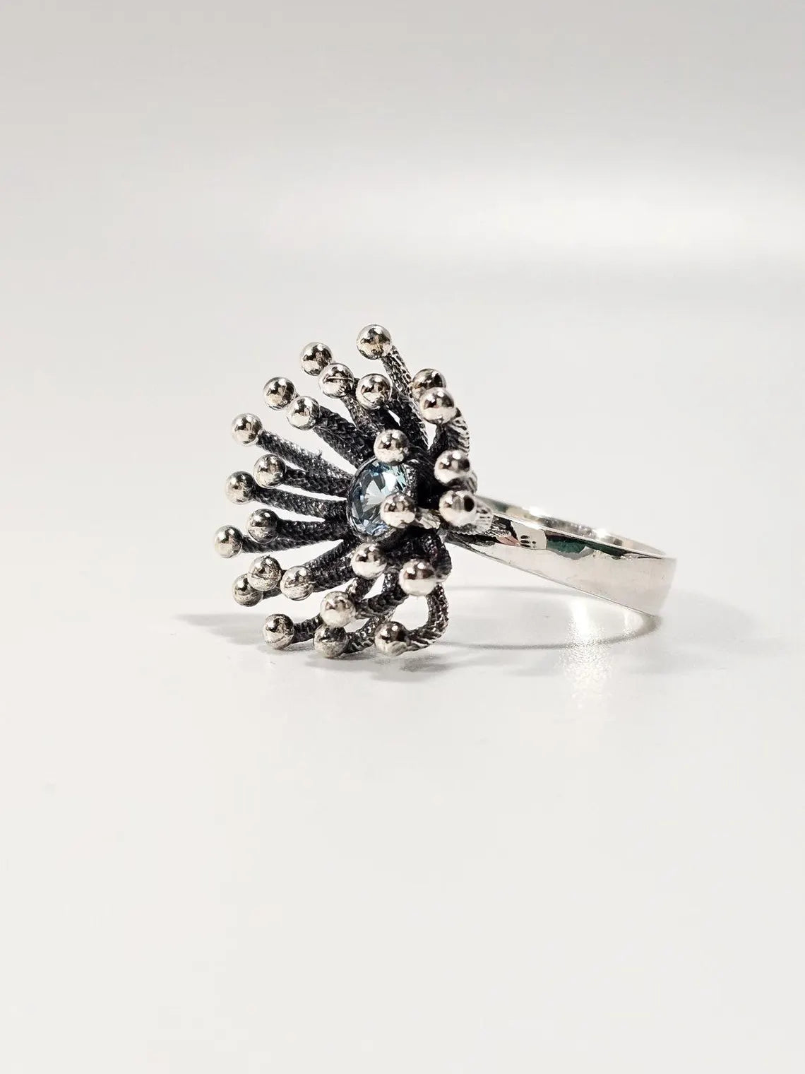 Side view of Dandelion silver ring showing beaded starburst design
