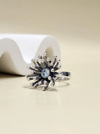 925 sterling silver Dandelion starburst ring with blue gemstone on display