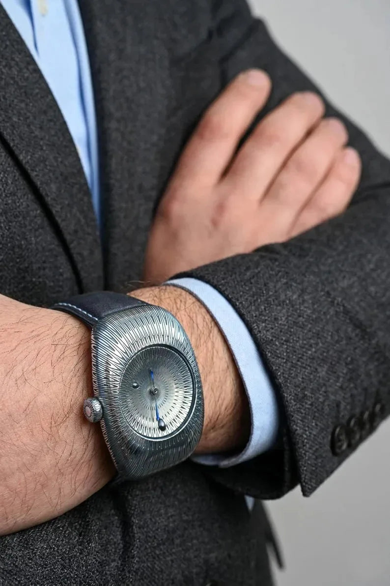 Luxury silver watch with blue enamel hands and antique detailing