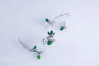 Minimalist sterling silver ear crawler with bamboo design and green accent
