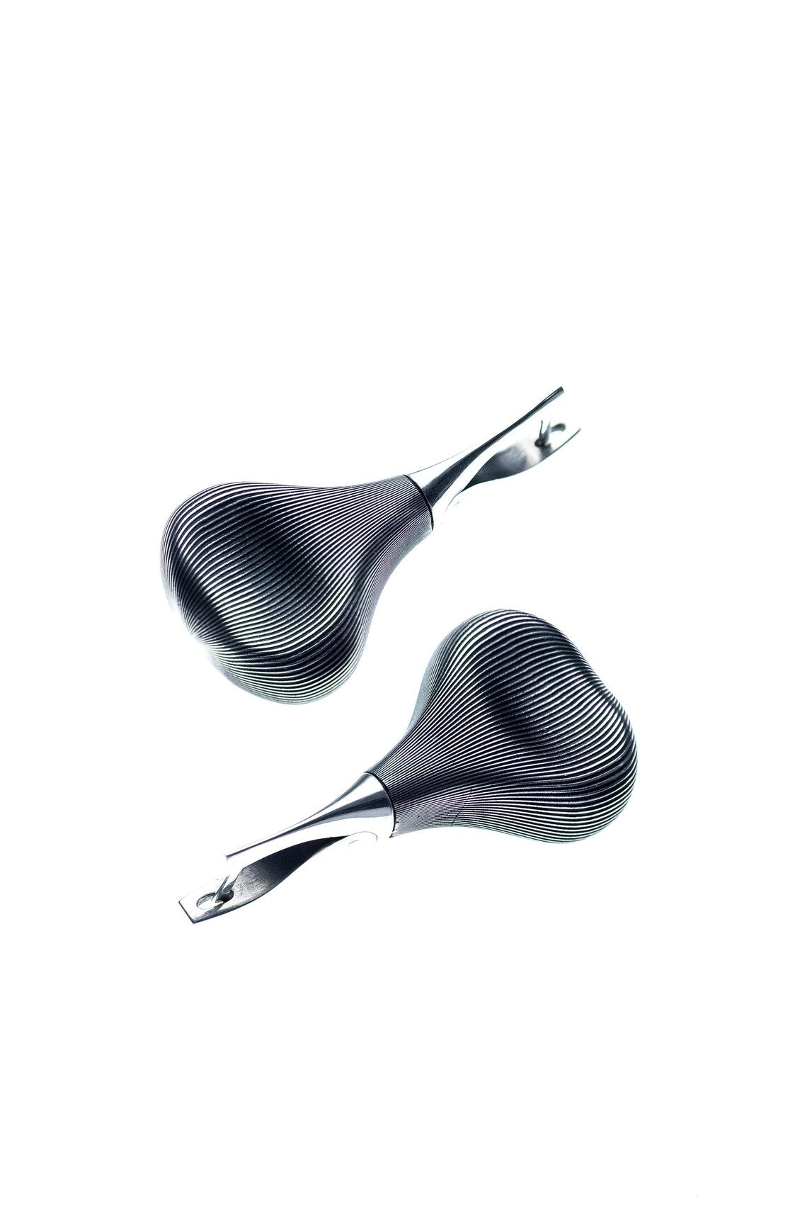 Two black hair clips with a textured design on a white background