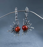 Statement sun motif earrings with natural coral stone