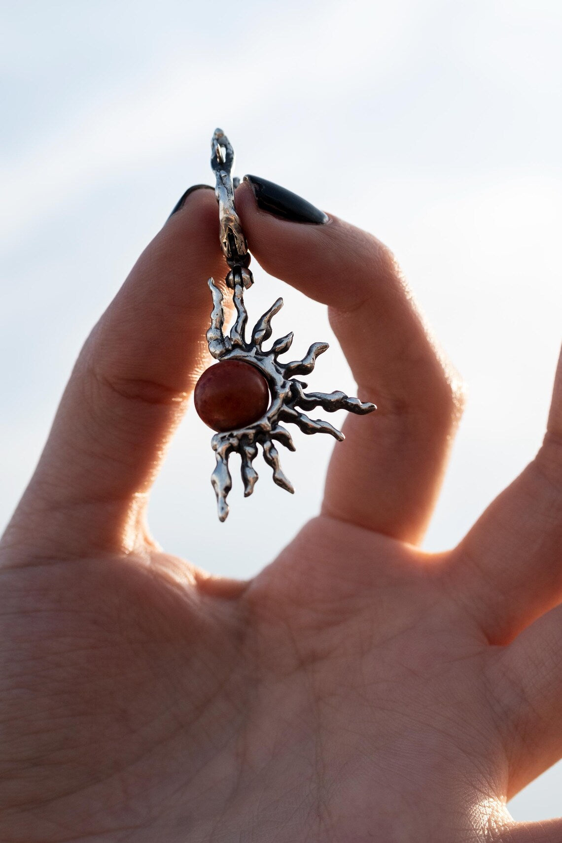 Handmade sterling silver sun earrings with red coral center
