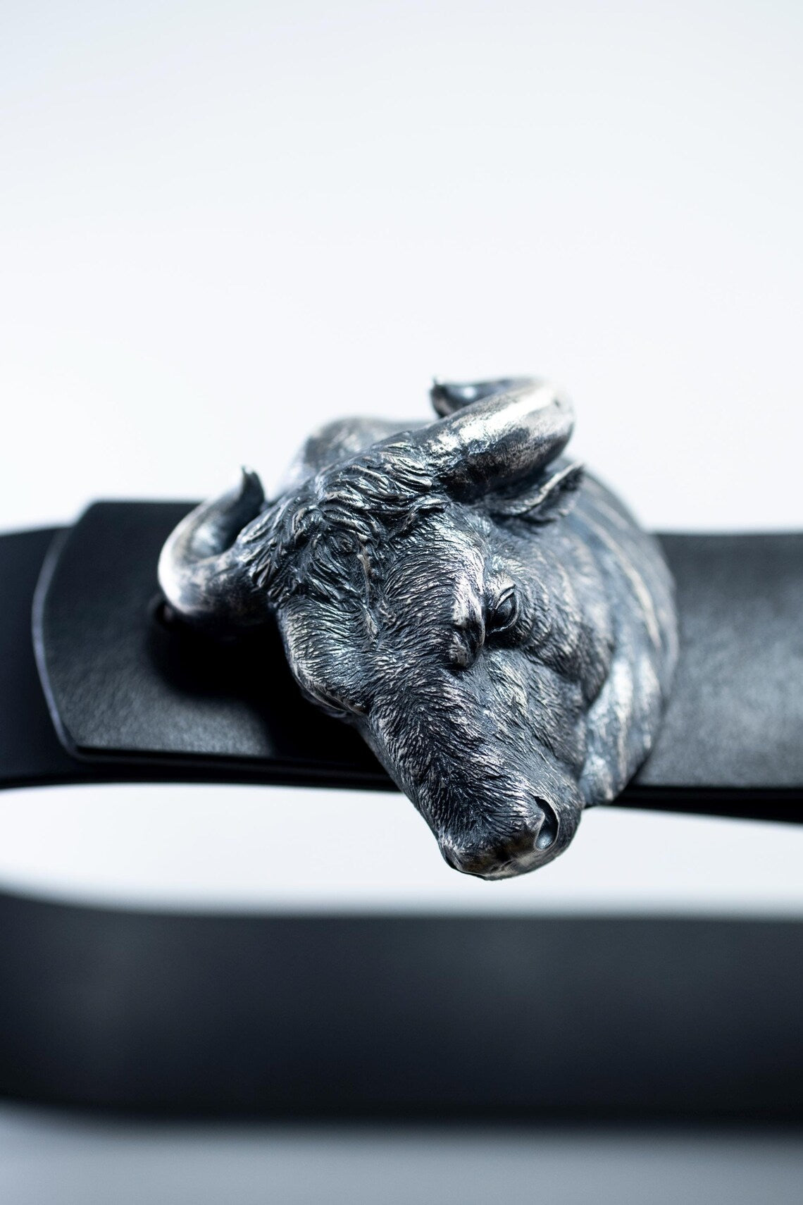 Handcrafted sterling silver bull head belt buckle on leather strap