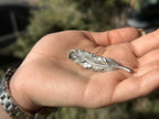 Handmade feather lapel pin close-up