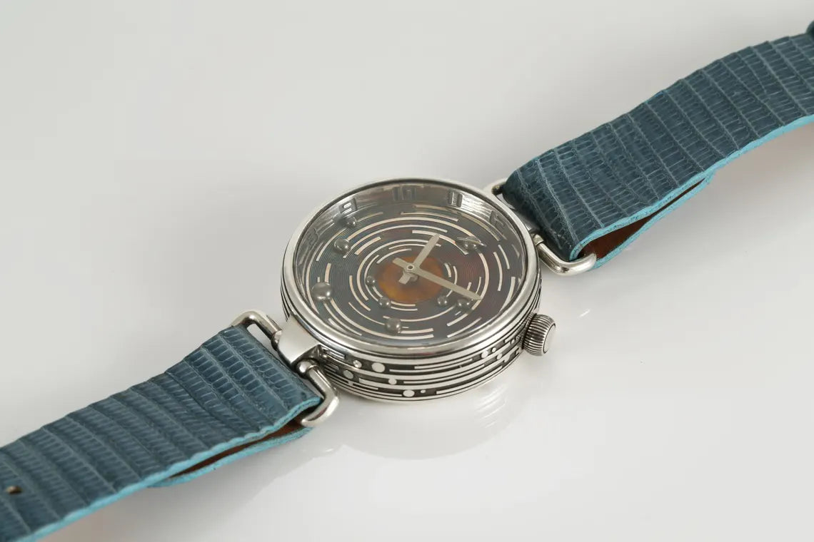 Wristwatch with blue strap on a light gray background