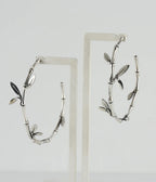Silver branch-shaped earrings on a white background