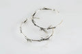 Sterling silver bamboo leaf hoop earrings with botanical design