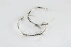 Sterling silver bamboo leaf hoop earrings with botanical design
