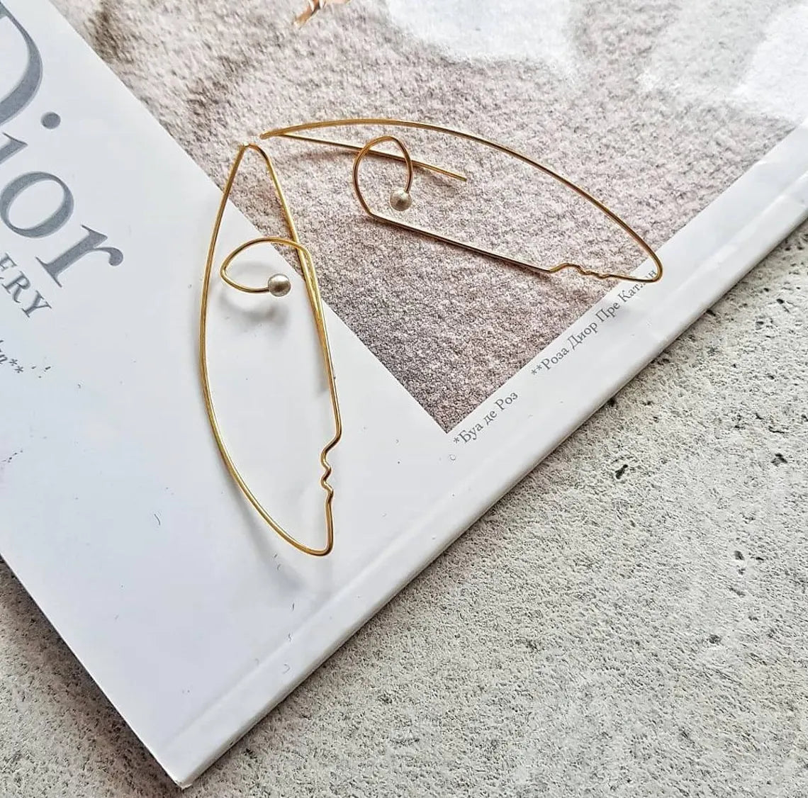 Modern sterling silver statement earrings with artistic face silhouette