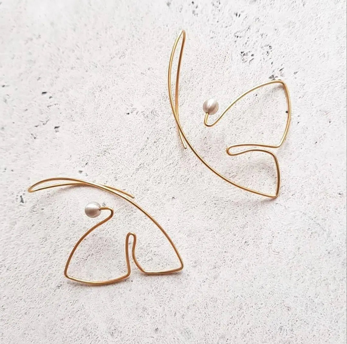 Minimalist line art earrings with artistic butterfly-inspired design