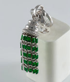 Silver tassel with green gemstones on a white background