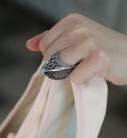 Sculptural sterling silver ring with red coral accent