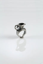 Artistic silver ring with iridescent stone
