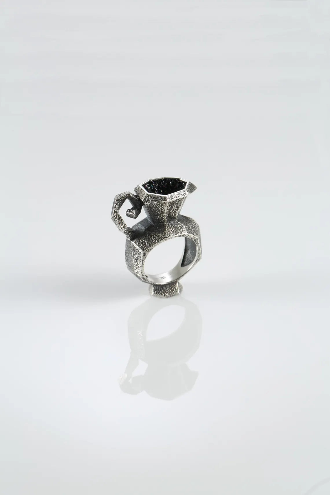 Artistic silver ring with iridescent stone