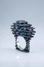 Handmade sculptural silver ring with blue stone