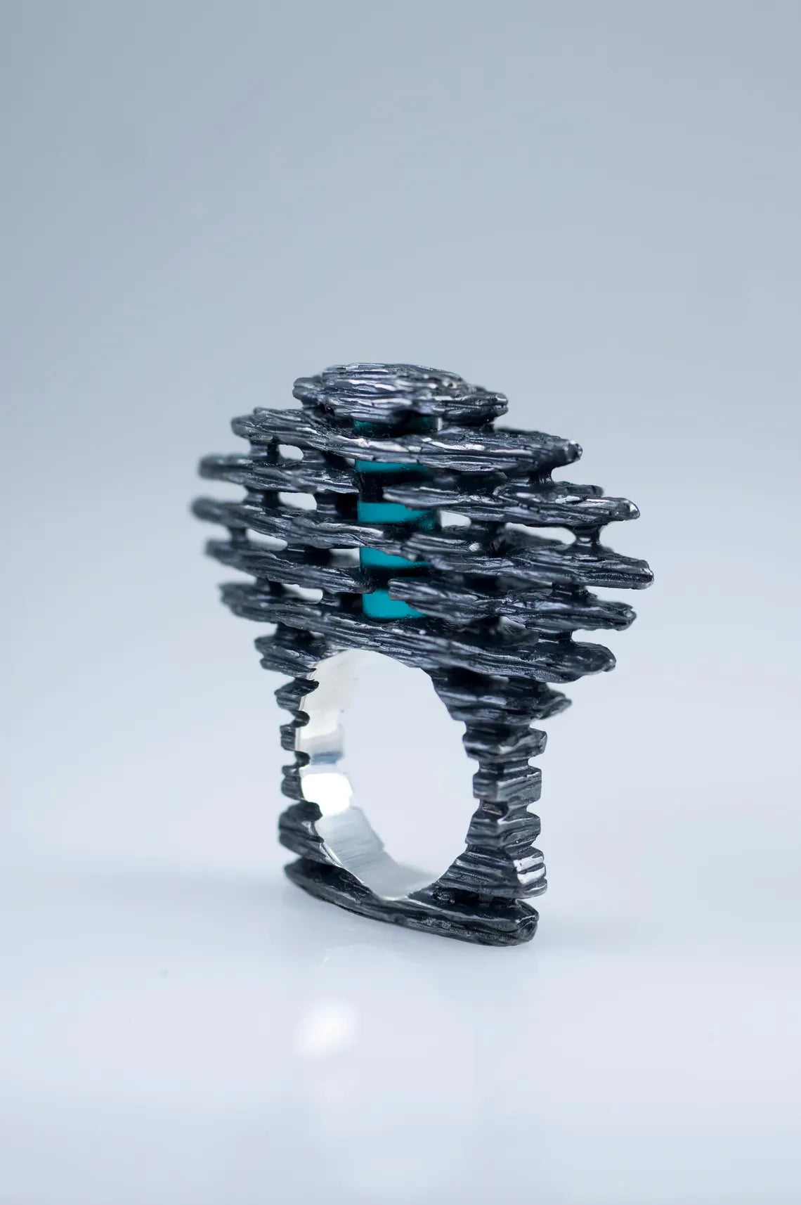 Handmade sculptural silver ring with blue stone