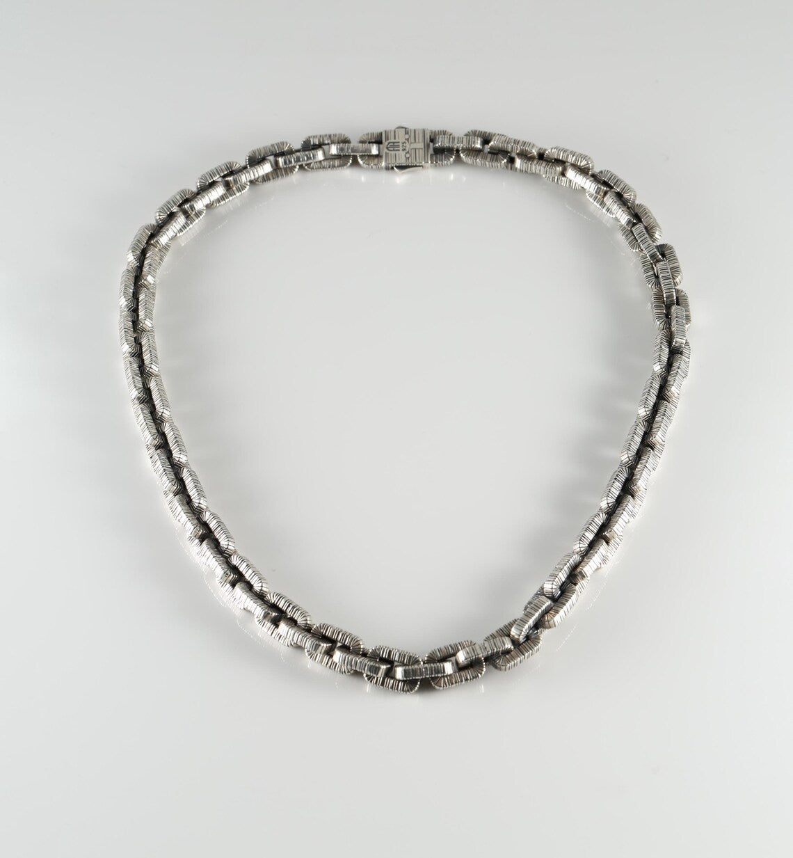 Textured chunky silver necklace on model