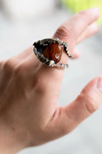 Organic textured statement ring with red gemstone