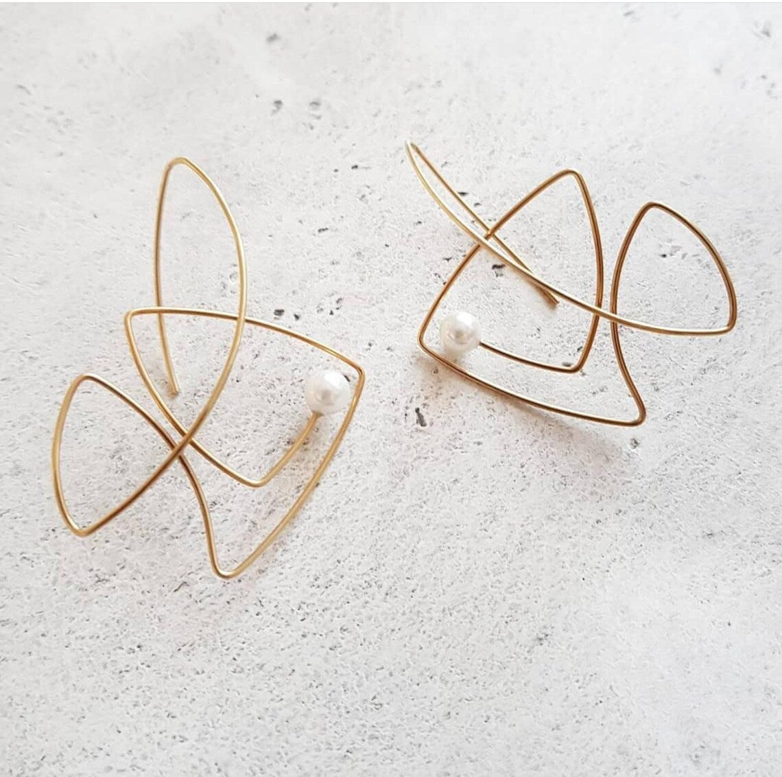 Handcrafted sterling silver fish earrings with pearl accents